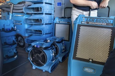Multiple dri-eaz pieces of equipment including airmovers and dehumidifiers. 