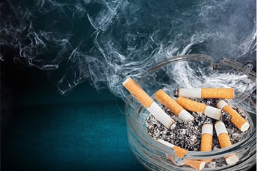 Cigarette putts in an ashtray smelling up the area needing odor control. 